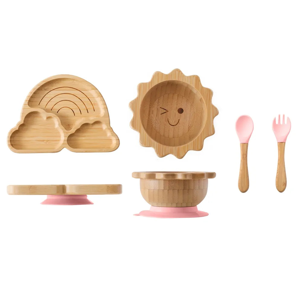 Bamboo plate and bowl set for toddlers, featuring a bright green silicone suction for secure placement