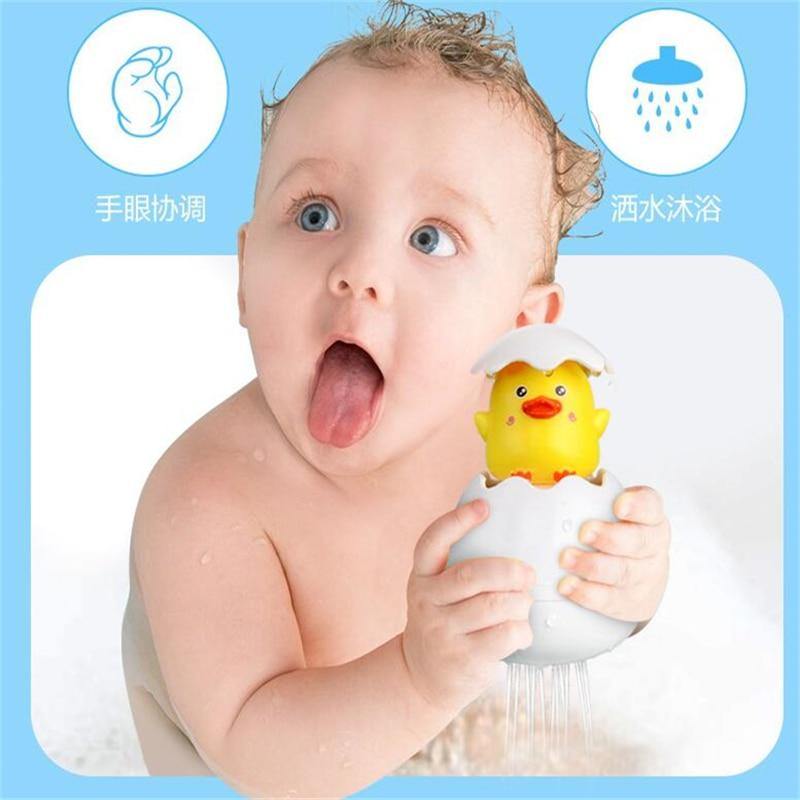 Toddler Bathtime fun: A hand holding a Hatching Animal Shower Toy with a blue dolphin, promoting interactive water play in the bath.