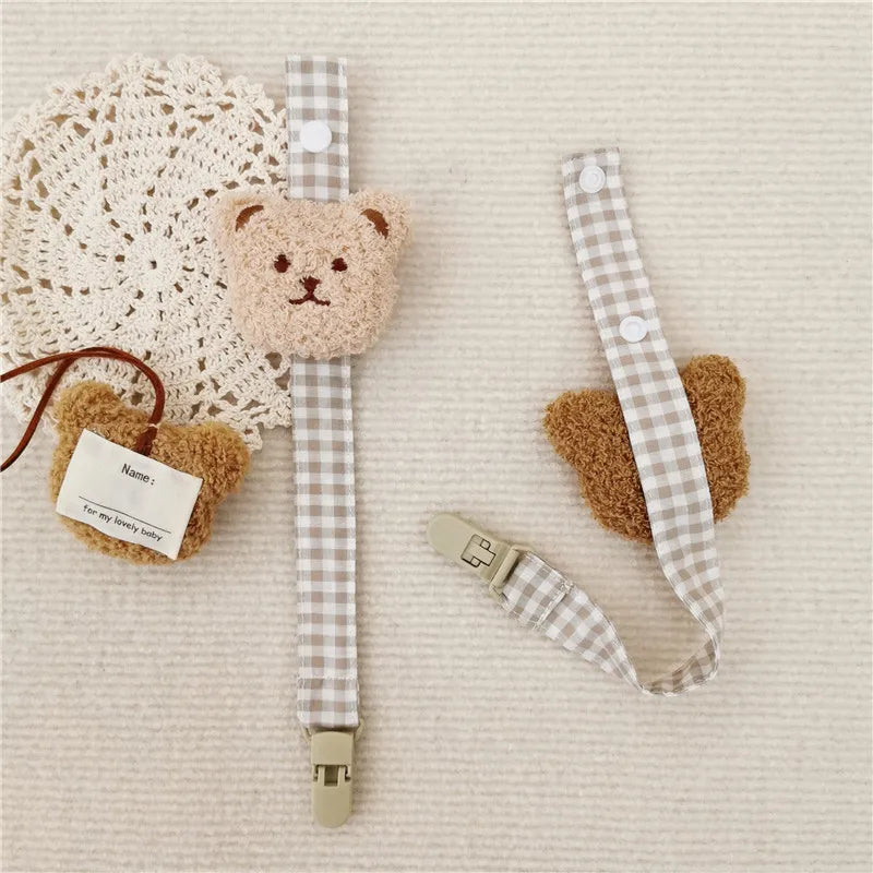 Secure baby soother clip with a playful bear motif, preventing floor contact