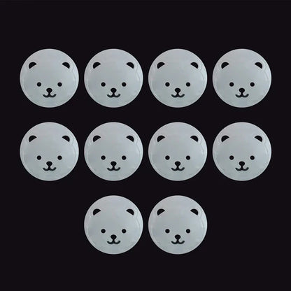 Close-up of a single white ABS plastic bear-shaped socket cover, essential child safety plug protector.