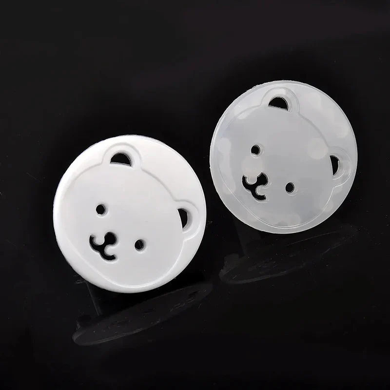 Ten white baby bear socket covers neatly packaged, ensuring home electrical safety for children.