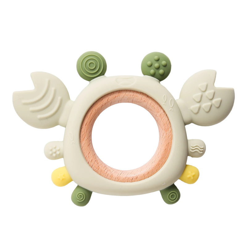 Soft green silicone crab teether toy on a wooden surface, perfect chew toy for infant gum soothing