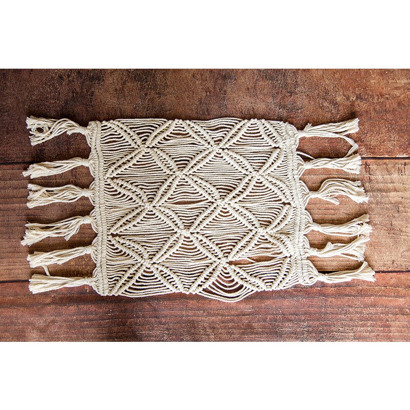 Close-up of a textured boho knitted baby blanket, a cozy and stylish photo prop