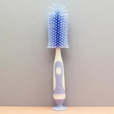Cleaning baby bottles with a long-handled brush from the complete pacifier cleaning set