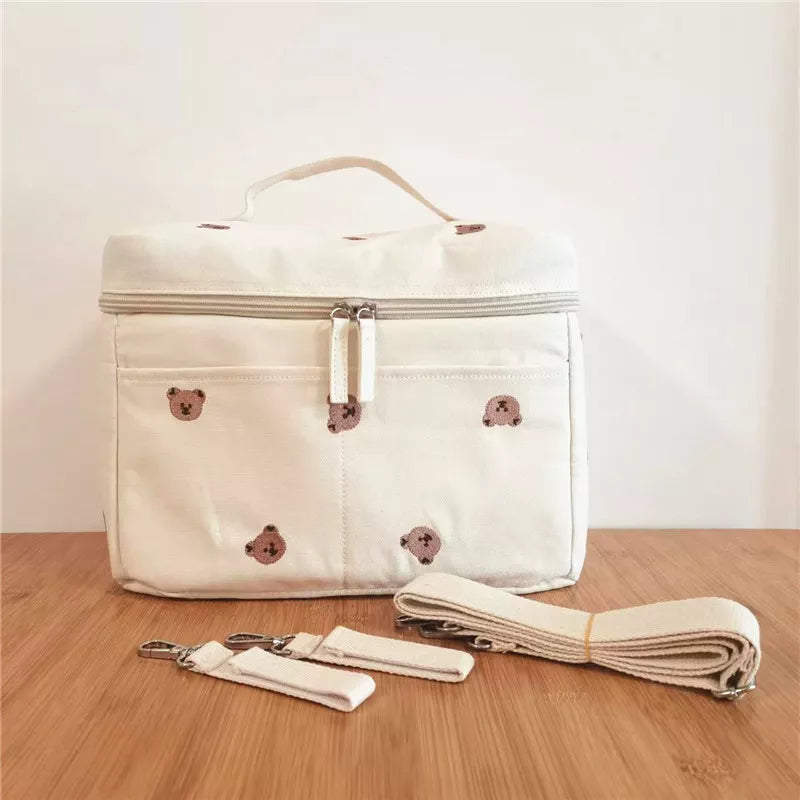 Front view of a baby bottle thermal bag, featuring a convenient strap for stroller attachment.