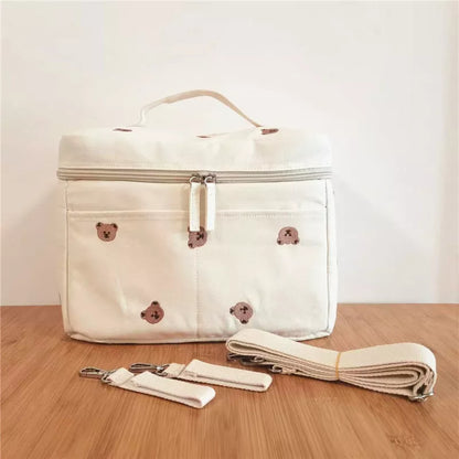 Front view of a baby bottle thermal bag, featuring a convenient strap for stroller attachment.
