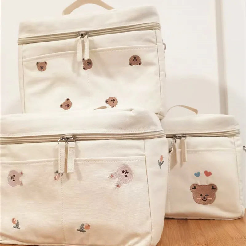 Close-up of a baby bottle cooler bag, insulated and ready for attachment to a stroller.