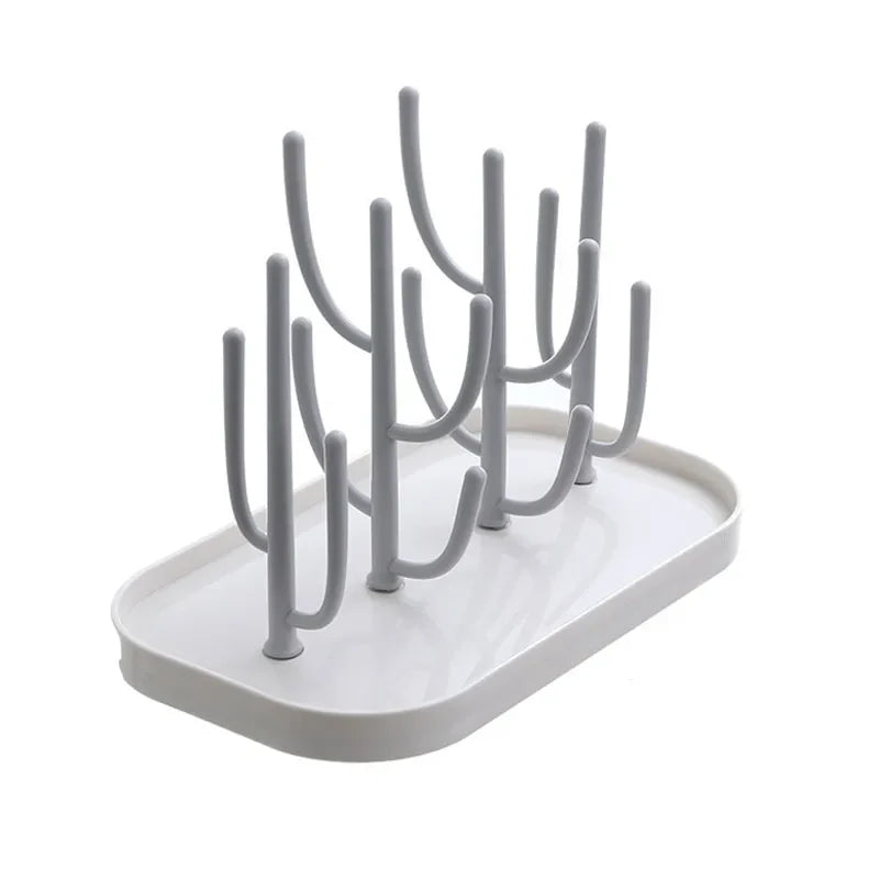 Overhead shot of a baby bottle drying rack with various sized pegs, effectively organizing baby feeding items