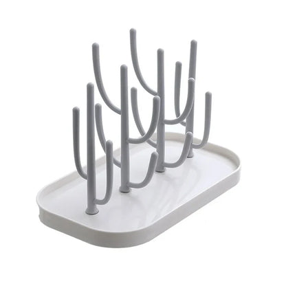 Overhead shot of a baby bottle drying rack with various sized pegs, effectively organizing baby feeding items