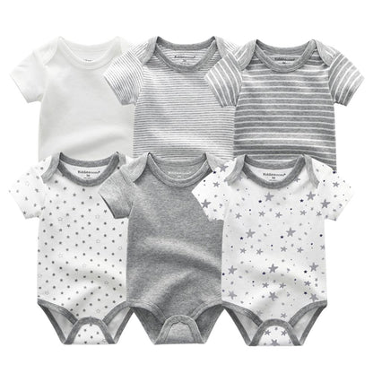 Table spread of the 6-pack baby boy cotton onesies, highlighting variety and quality