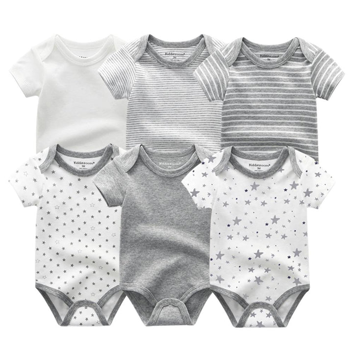 Table spread of the 6-pack baby boy cotton onesies, highlighting variety and quality