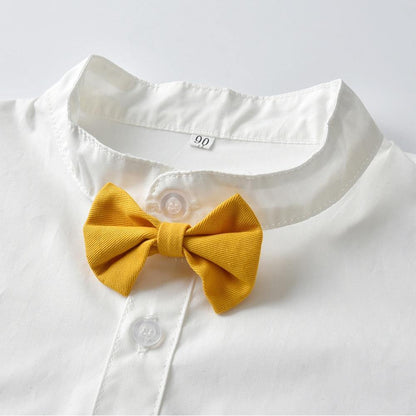 Full view of infant formal wear: a baby boy's elegant tuxedo set with black trousers and classic bow tie detail