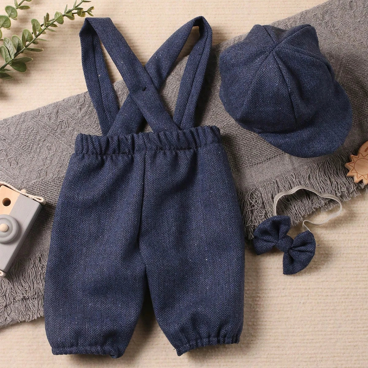 Close up of baby boy outfit's suspenders and intricate details, newborn photography prop