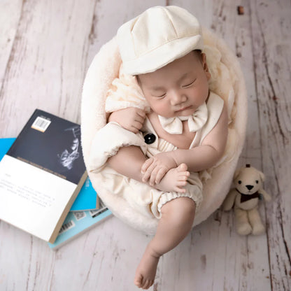 Close-up of baby boy gentleman outfit bow tie and suspenders, newborn clothing accessory