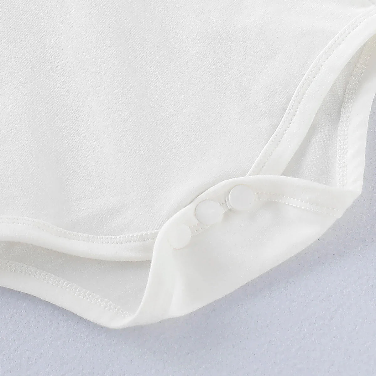 Side view of a baby boy gentleman romper, showcasing the tailored shorts and suspender design, all sizes