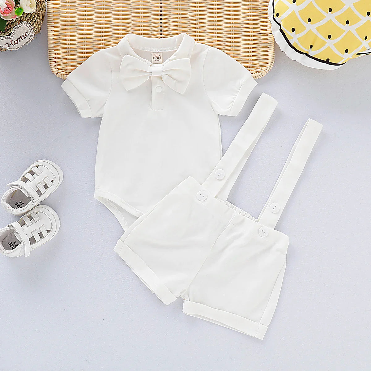 Newborn baby boy gentleman romper, complete with white shirt effect and attached patterned bow, great for photos