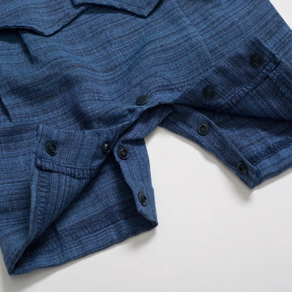 Adorable baby boy's formal romper in white and navy, complete with a dapper attached tie.