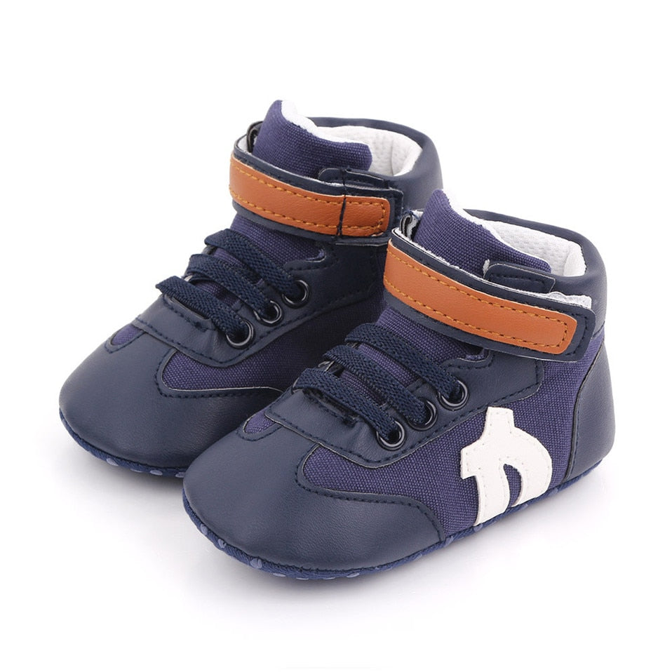 Soft sole baby boy first walker sneakers, hi-cut ankle support in durable blue canvas.