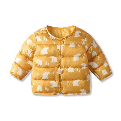 Close-up of baby girls dinosaur parka, warm winter jacket with cartoon print details