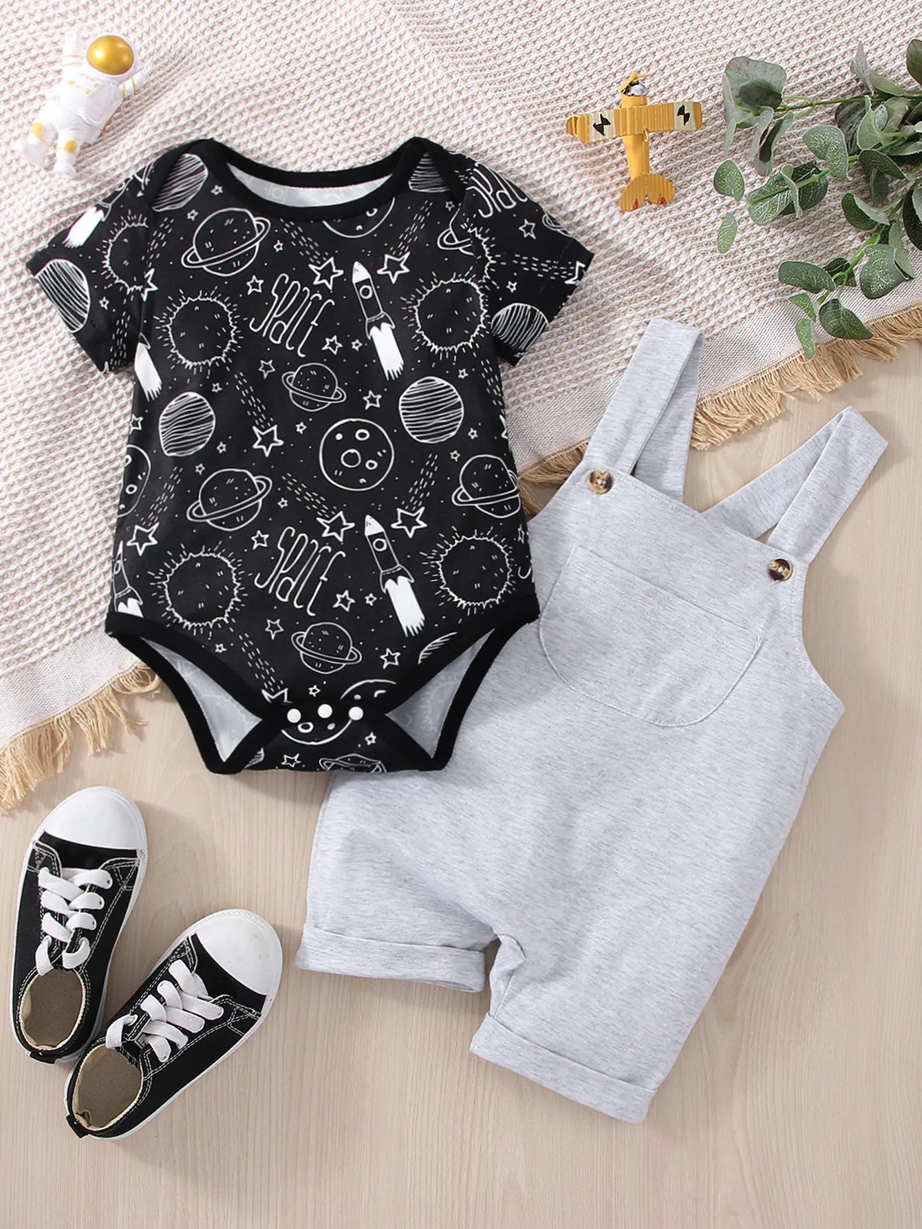 Baby boy in astronaut graphic romper, blue, short sleeve, cotton blend, playing on blanket