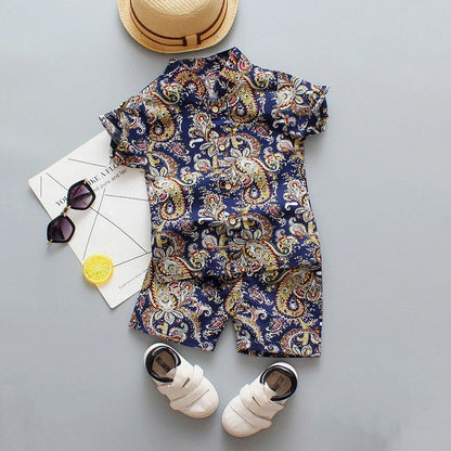 Baby boy fashion: white t-shirt with floral print & blue shorts outfit, adorable and breathable.