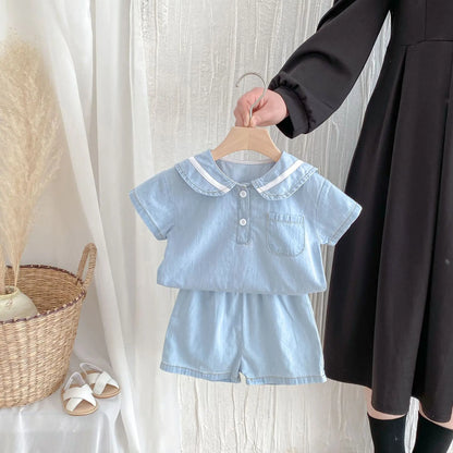 Close-up of sailor collar on baby boy's denim set, white trim, red ascot, Korean style kids fashion