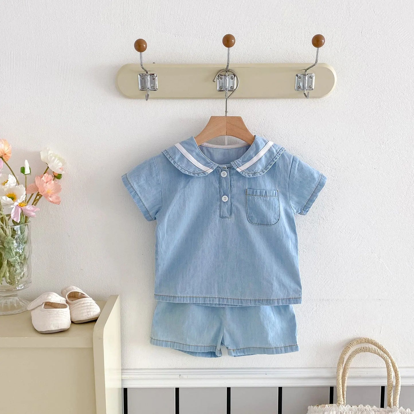 Toddler boy wearing blue denim sailor collar set, standing, back view, summer outfit, elastic waist shorts