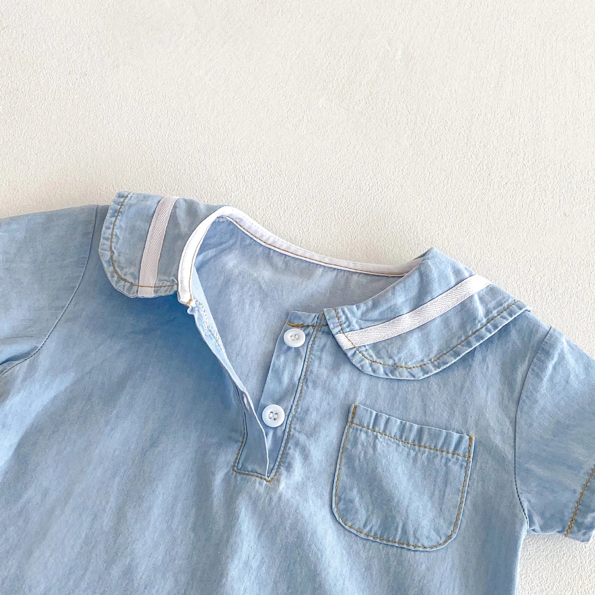 Full shot of baby boy's summer denim set, sailor collar shirt and shorts, perfect for warm weather
