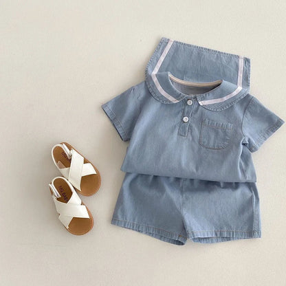 Adorable baby boy sitting, dressed in a Korean denim sailor collar set, comfortable and stylish toddler wear