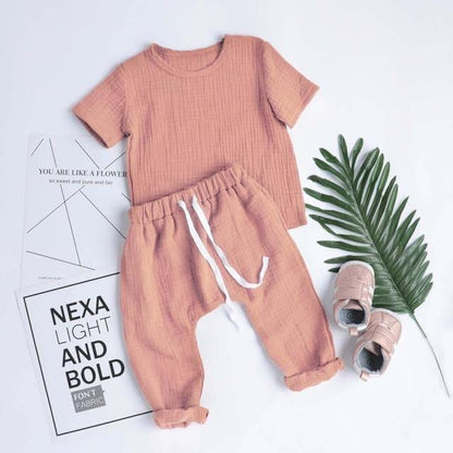 Unisex infant in a comfortable blue and white plaid cotton bodysuit, ideal for newborns