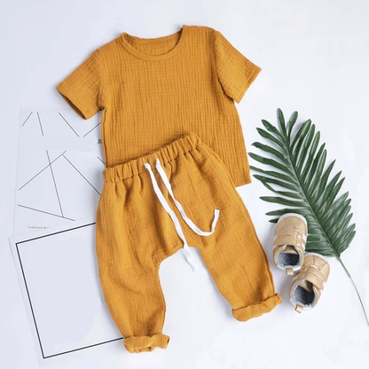 Toddler modeling a stylish cotton plaid bodysuit set, demonstrating comfort and baby fashion