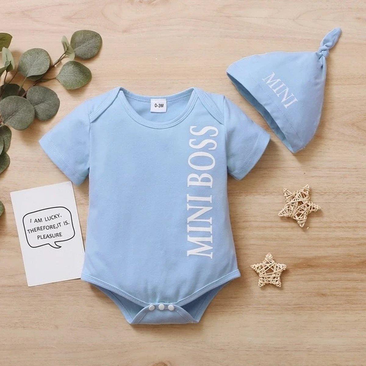 Two-piece baby boy outfit: 'Mini Boss' short sleeve romper and coordinating hat, side view