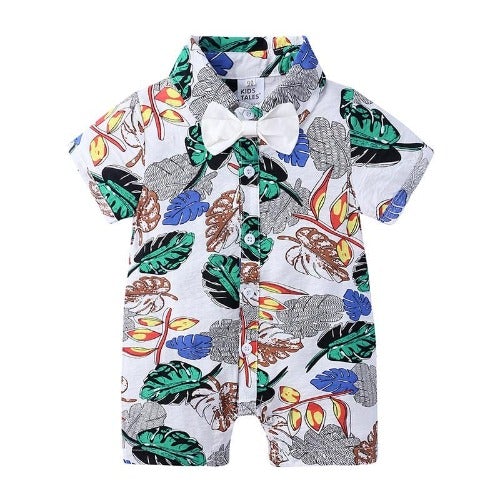 Close-up of a baby boy's leaf print romper, showcasing the fabric texture and decorative bow tie.