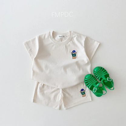 A full shot of a baby boy's outfit, including a bear-themed t-shirt and basic shorts, cotton blend