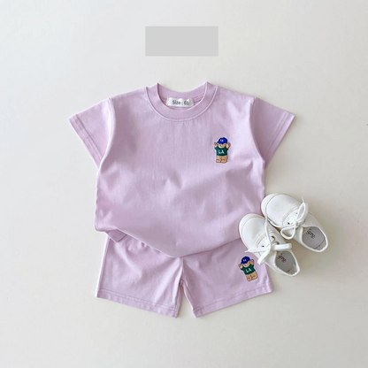 Close-up of bear embroidery on a baby boy's blue cotton blend t-shirt, cute infant apparel detail