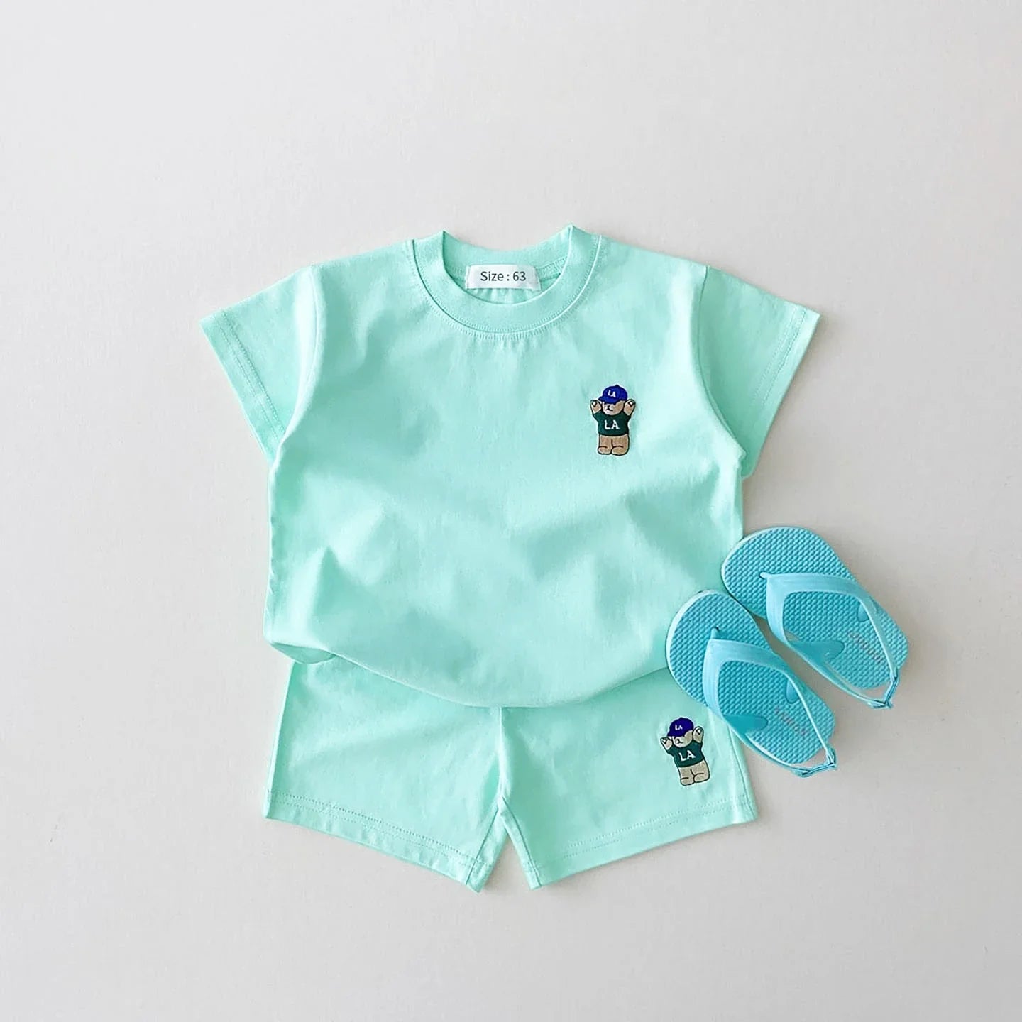 Folded baby boy's bear embroidery t-shirt and shorts set, ready for summer casual wear