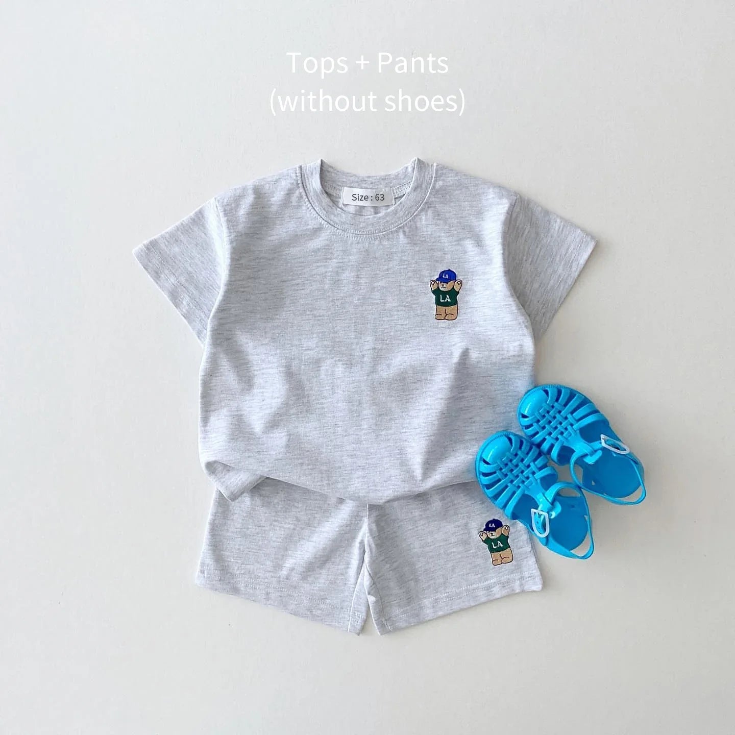 Bear embroidered patch on a soft cotton blend t-shirt, part of a baby boy's summer playset