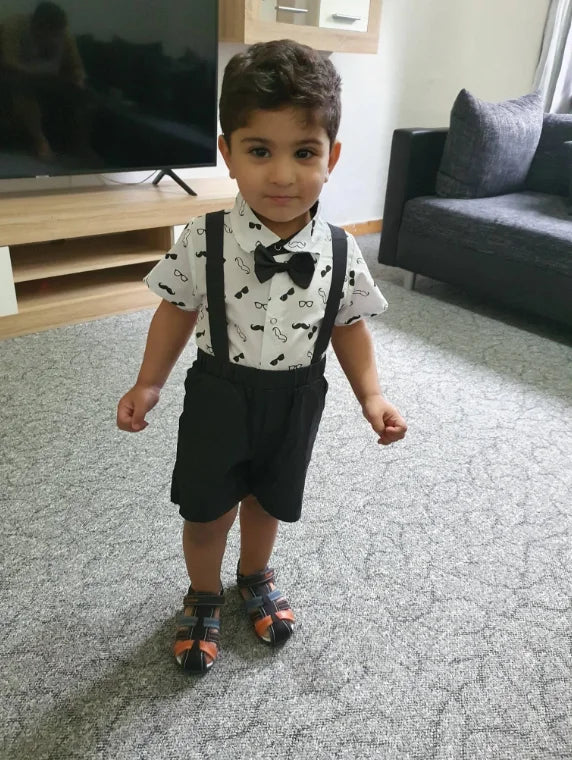 Baby boy's complete formal outfit, white bow tie bodysuit and navy blue suspender pants