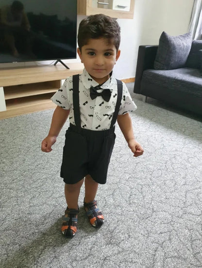 Baby boy's complete formal outfit, white bow tie bodysuit and navy blue suspender pants