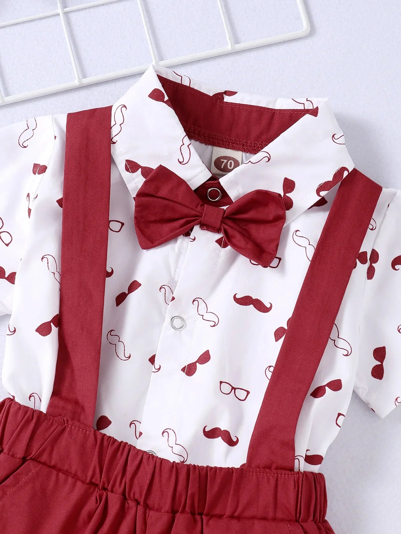 Infant gentleman set: white cotton bodysuit with attached bow tie and navy suspender bottoms