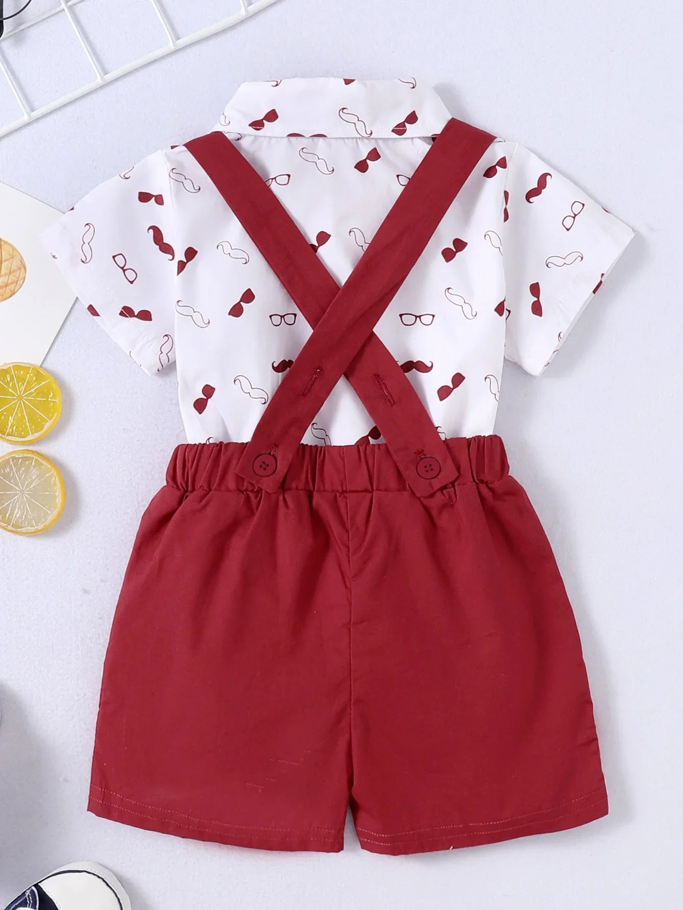 Stylish baby boy formal wear, bow tie bodysuit paired with classic suspender pants, comfortable