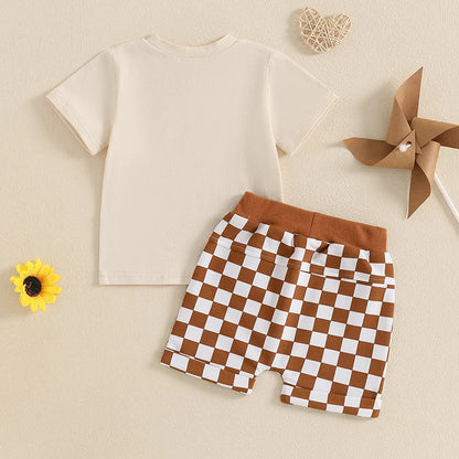 Adorable baby boy's two-piece outfit with a graphic tee and black and white checkerboard shorts.