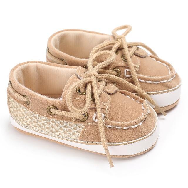 Baby boy's blue canvas loafer shoes, featuring a soft sole for comfortable first walks.
