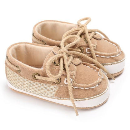 Baby boy's blue canvas loafer shoes, featuring a soft sole for comfortable first walks.