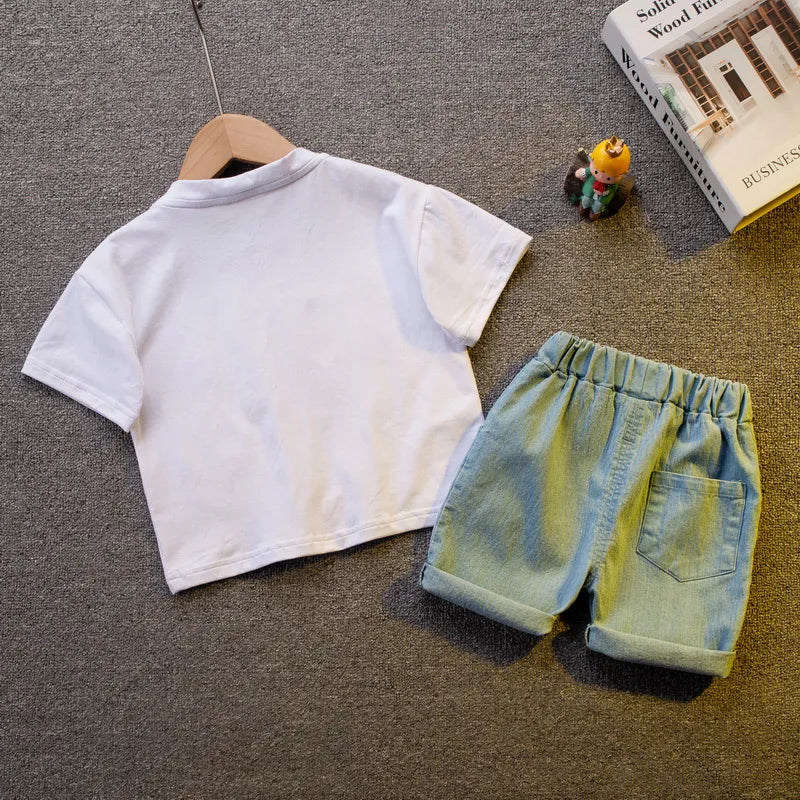Close-up of a baby boy in a casual summer outfit: blue O-neck shirt and comfortable striped shorts.