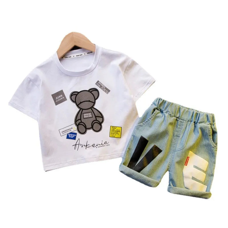 Full view of a baby boy's two-piece summer fashion set, including a blue shirt and patterned shorts.