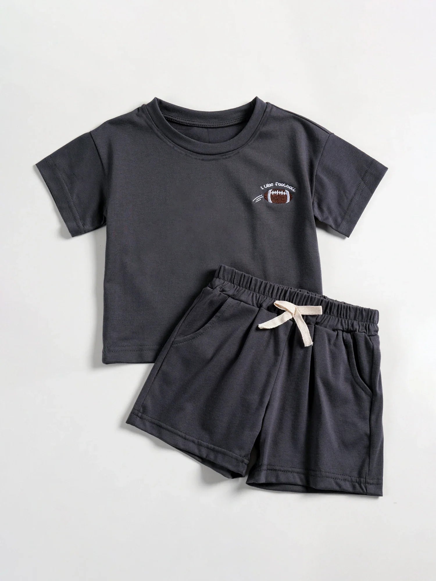 Toddler boy's summer outfit: white short-sleeve tee with daisy motif, matching blue shorts