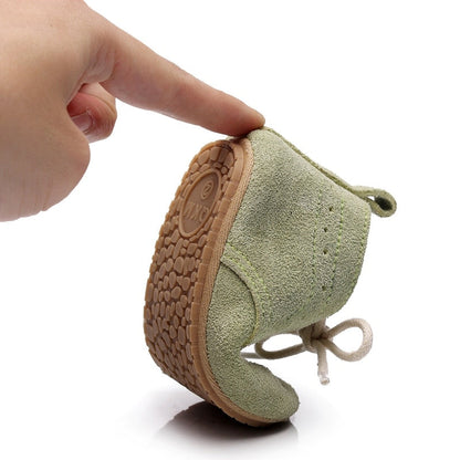 Close-up of baby boy first walker shoes, soft leather with breathable design for new walkers