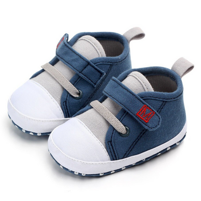 Close-up of tri-color baby boy first walker sneaker with soft sole and secure laces