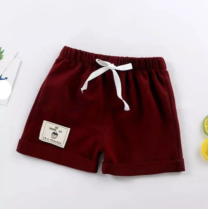 Close-up of the drawstring detail on casual navy blue toddler shorts, adjustable and comfy.